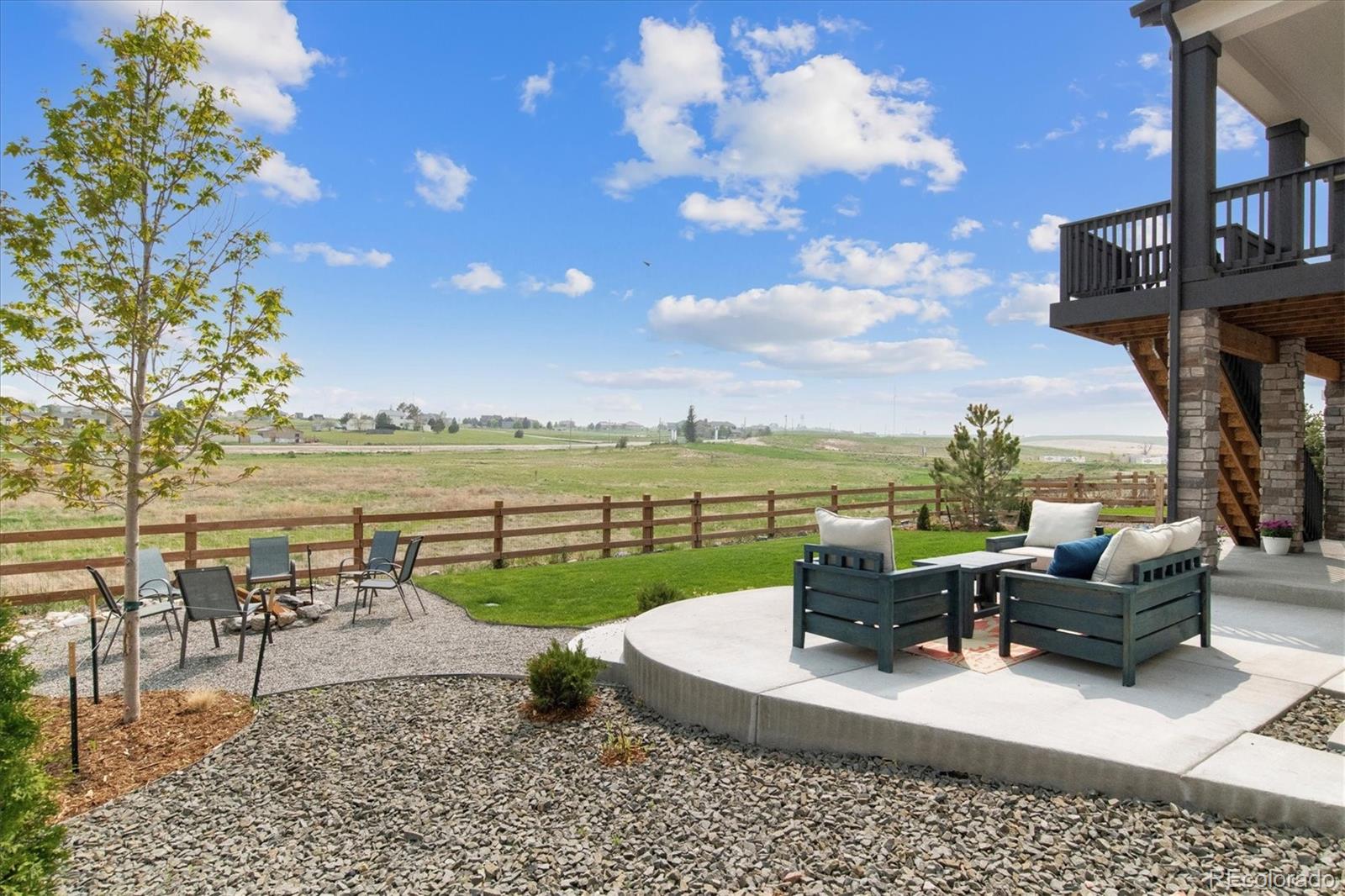 1142 Williams Loop Elizabeth, CO 80107 - Photo 30 of 38 a view of a patio with lawn chairs floor to ceiling window and lake view