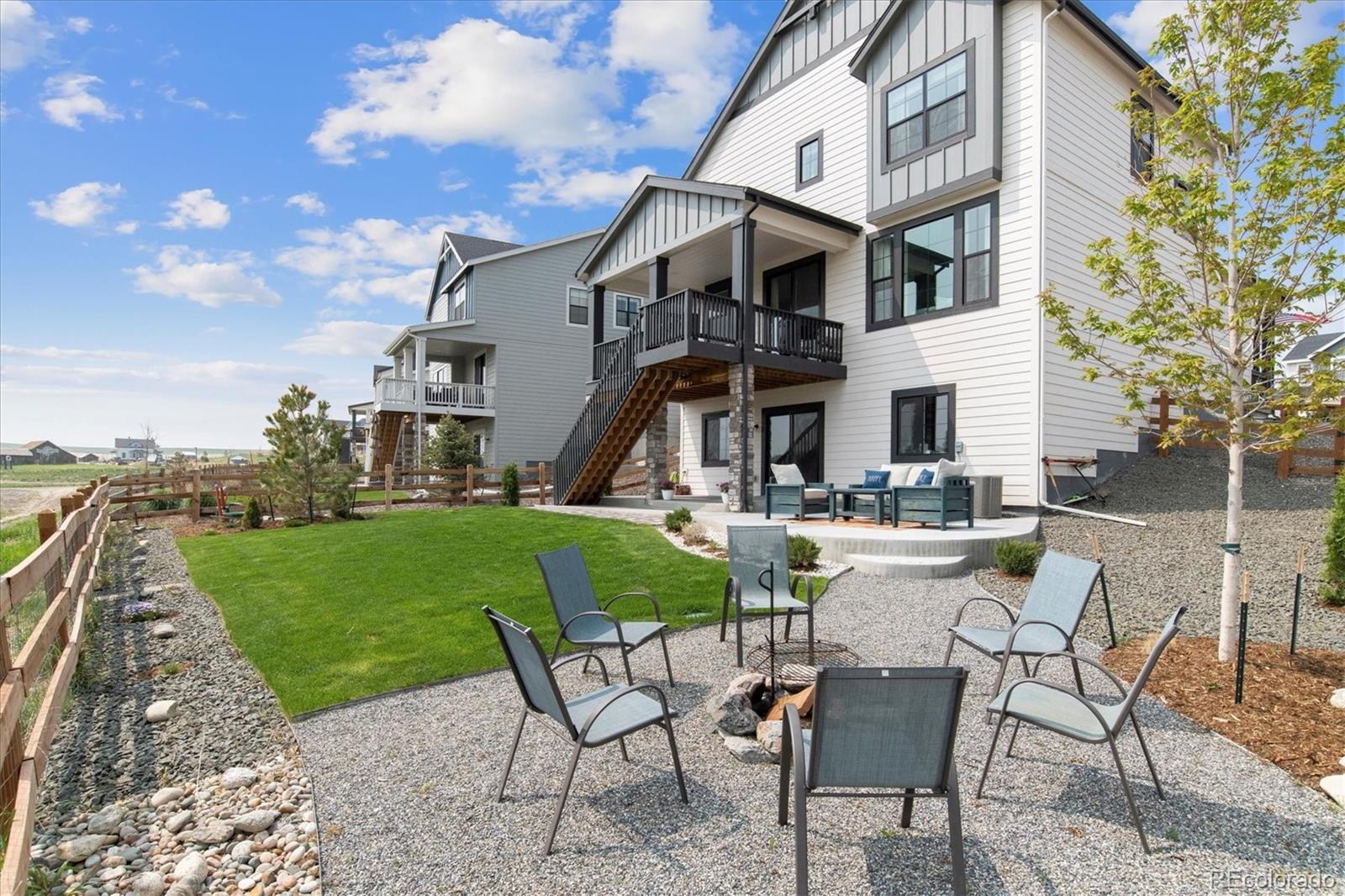 1142 Williams Loop Elizabeth, CO 80107 - Photo 34 of 38 a view of a white house with a yard table and chairs