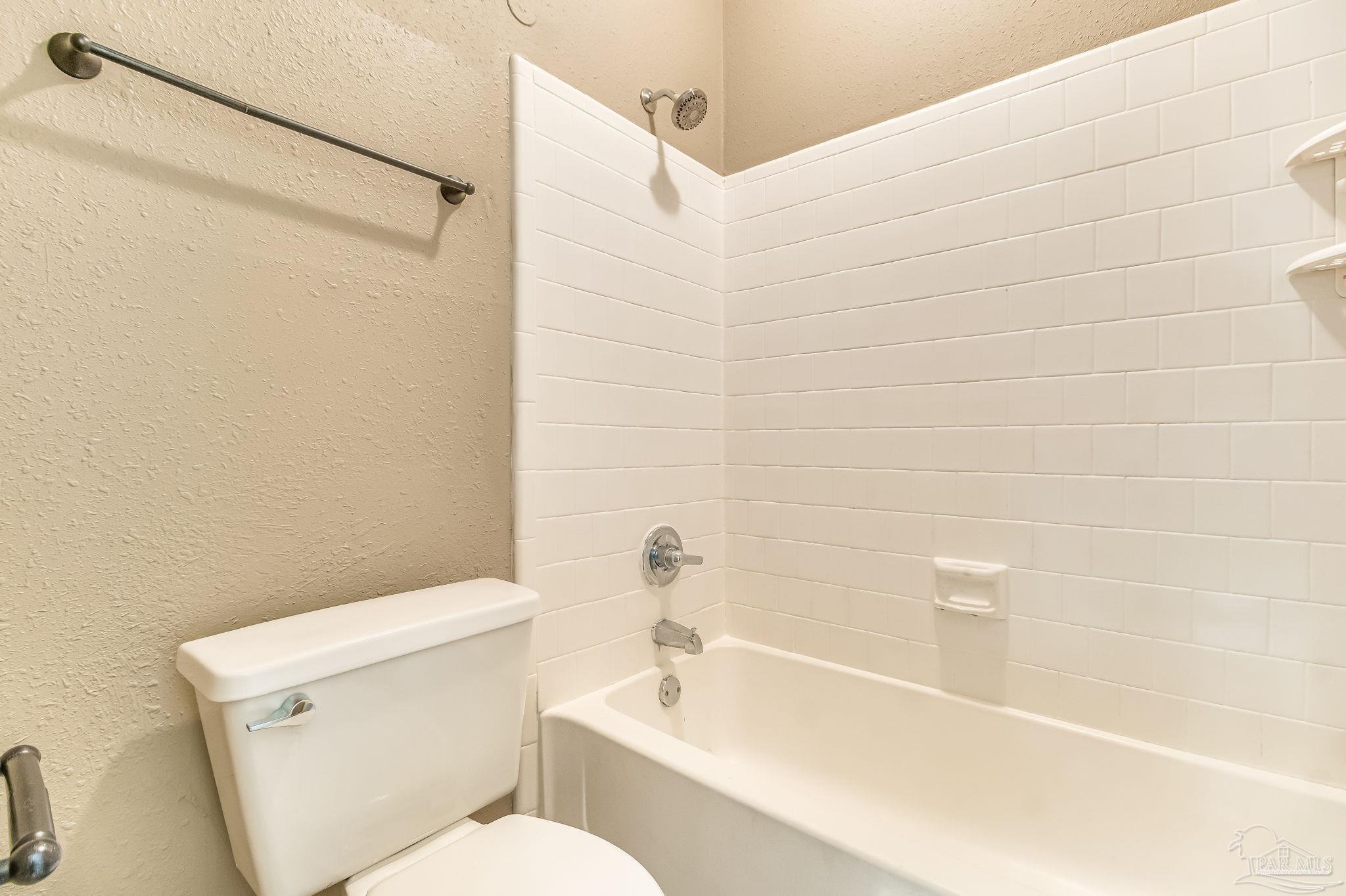 4554 Northpointe Place Pensacola, FL 32514 - Photo 13 of 42 a white bath tub sitting next to a white toilet