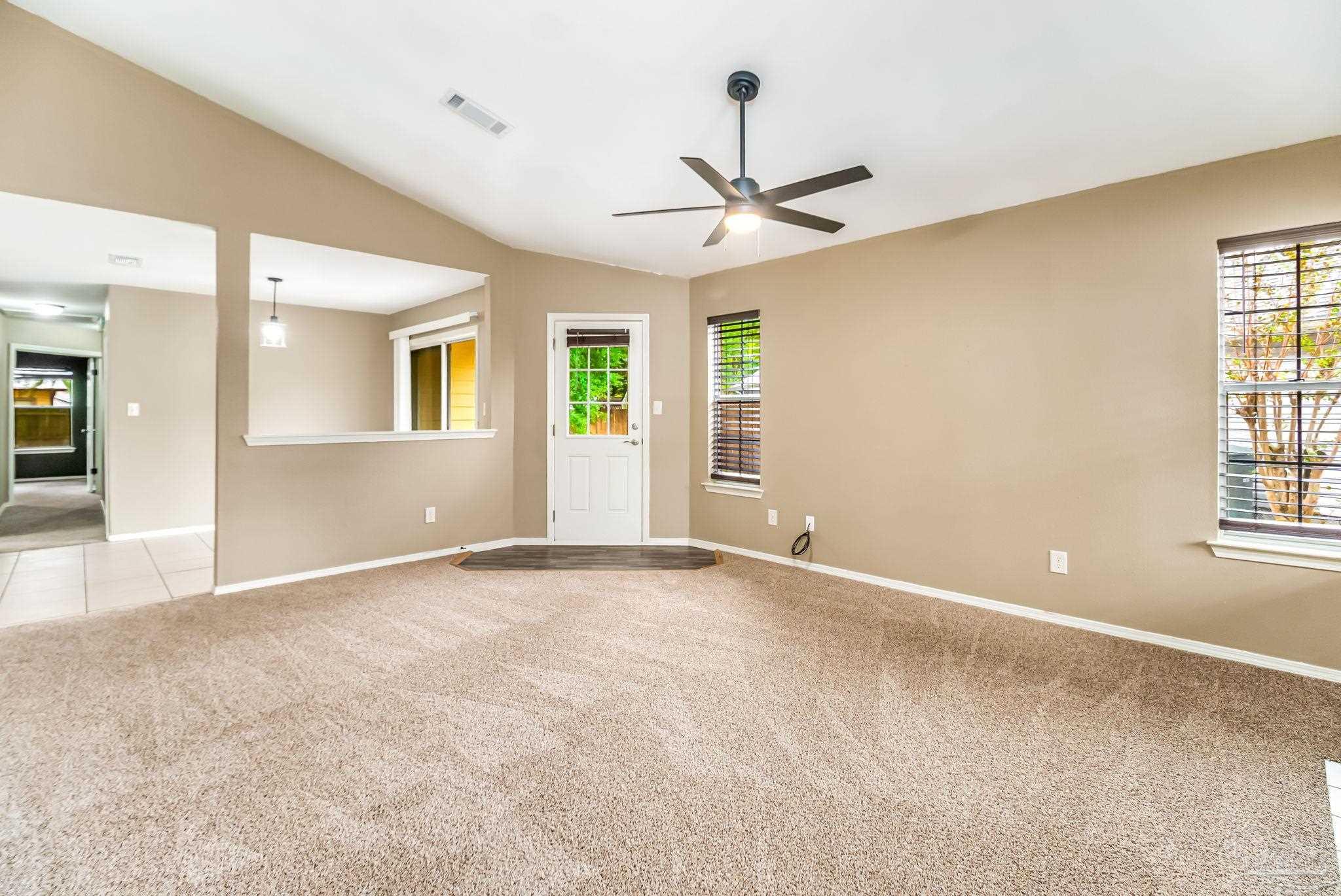 4554 Northpointe Place Pensacola, FL 32514 - Photo 15 of 42 an empty room with windows and ceiling fan