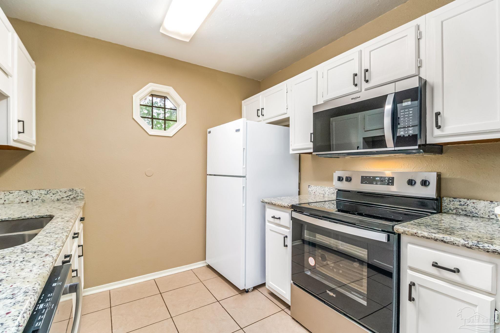 4554 Northpointe Place Pensacola, FL 32514 - Photo 22 of 42 a kitchen with granite countertop cabinets stainless steel appliances and a counter space