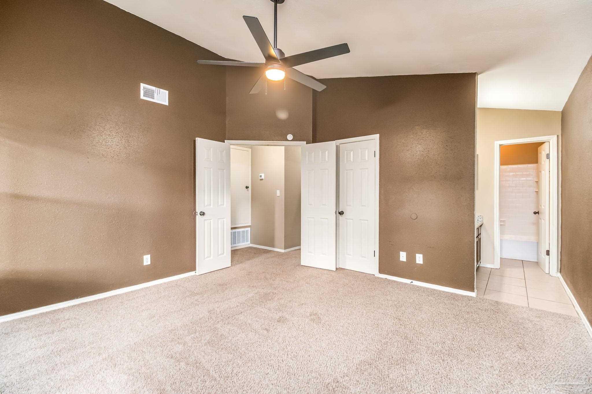 4554 Northpointe Place Pensacola, FL 32514 - Photo 25 of 42 a view of a livingroom with a chandelier fan and windows