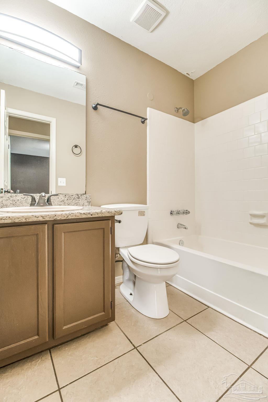4554 Northpointe Place Pensacola, FL 32514 - Photo 29 of 42 a bathroom with a toilet sink and mirror