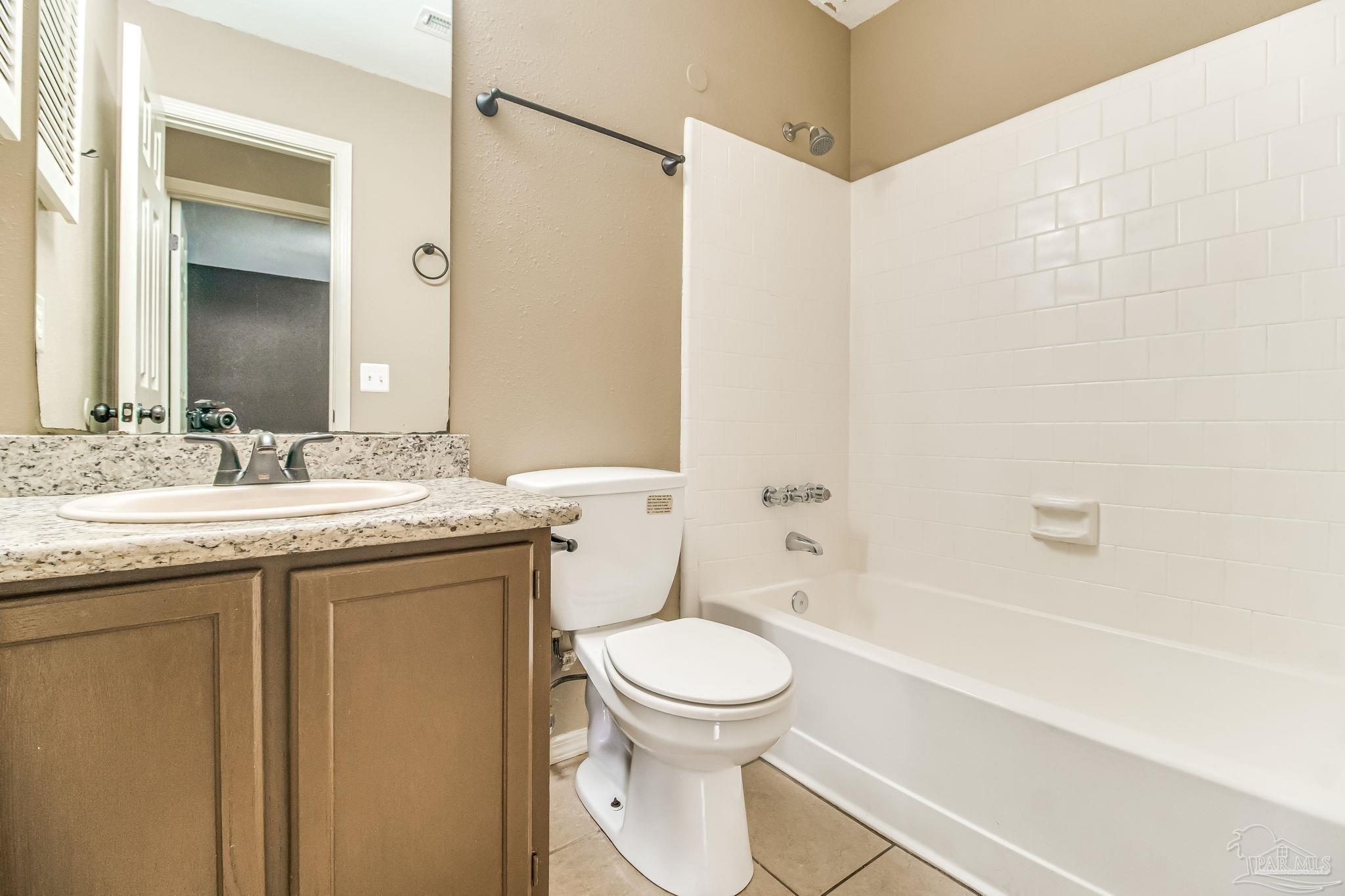4554 Northpointe Place Pensacola, FL 32514 - Photo 30 of 42 a bathroom with a granite countertop sink toilet and shower