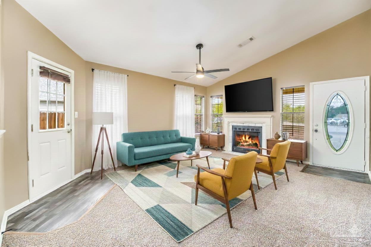 4554 Northpointe Place Pensacola, FL 32514 - Photo 3 of 42 a living room with furniture a fireplace and a flat screen tv