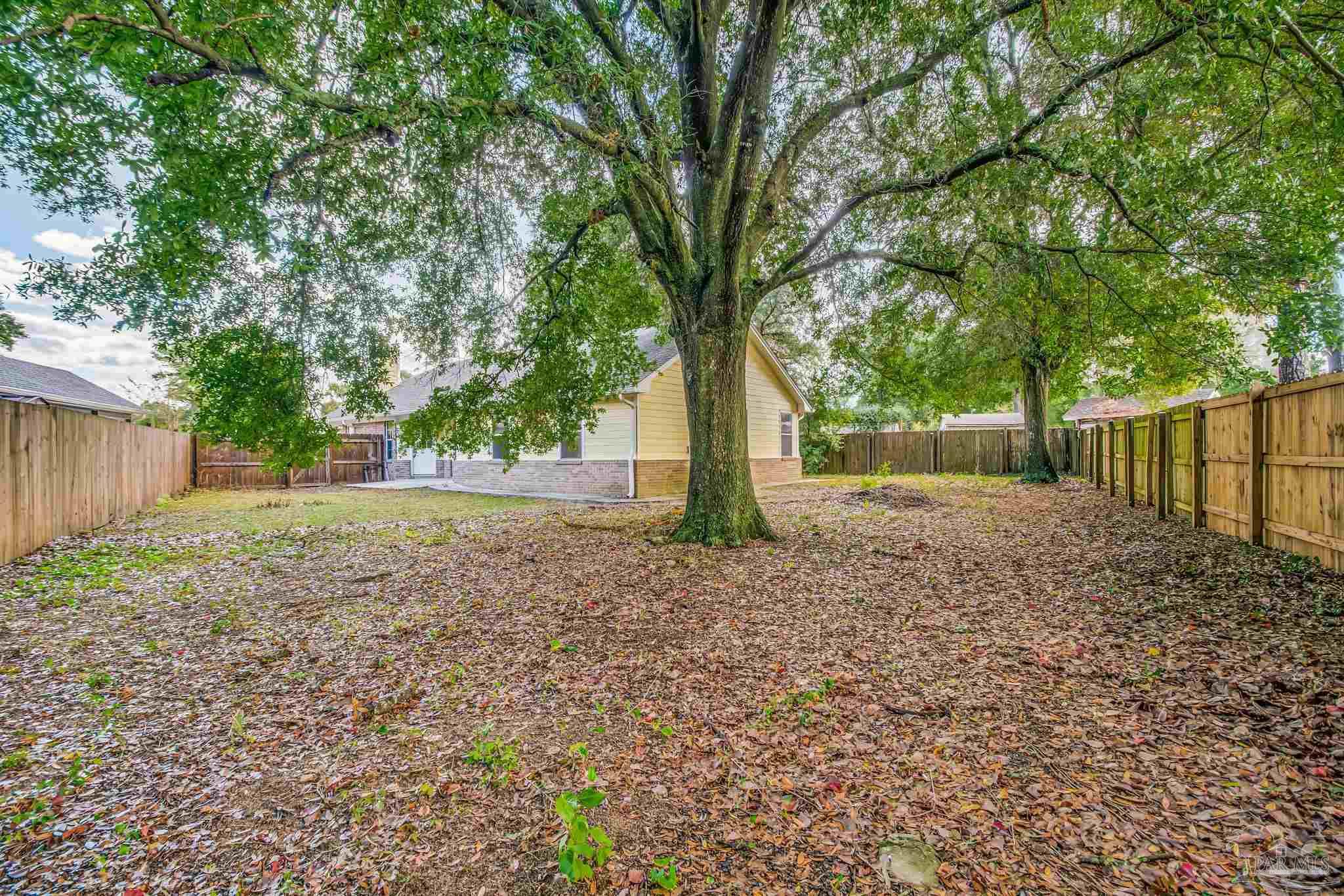 4554 Northpointe Place Pensacola, FL 32514 - Photo 40 of 42 a backyard of a house with lots of green space