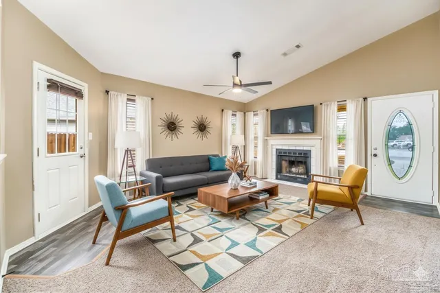 a view of an empty room with a fireplace and a window
