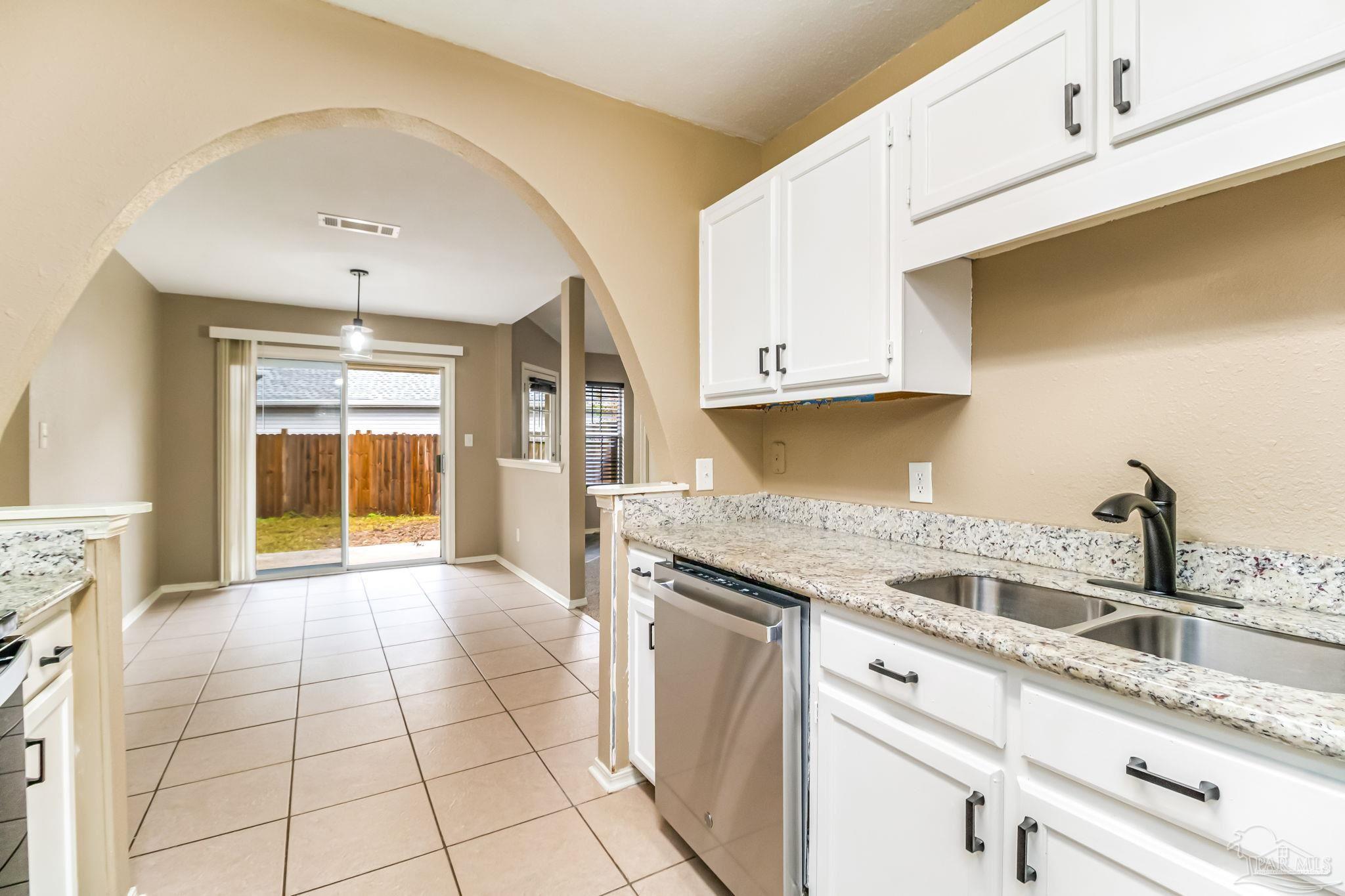 4554 Northpointe Place Pensacola, FL 32514 - Photo 5 of 42 a kitchen with a sink stove and cabinets