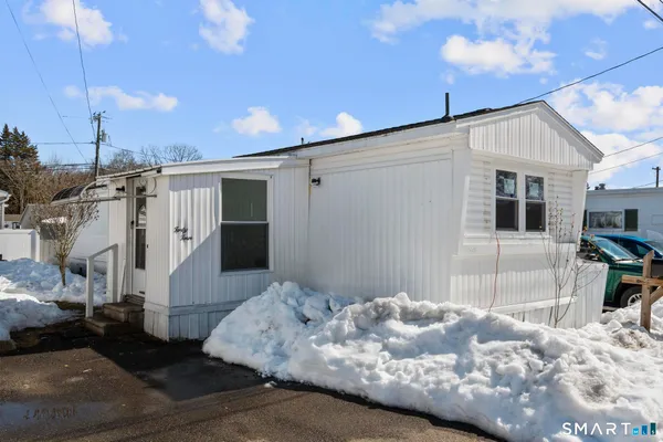 a bedroom with a bed and a view of living room