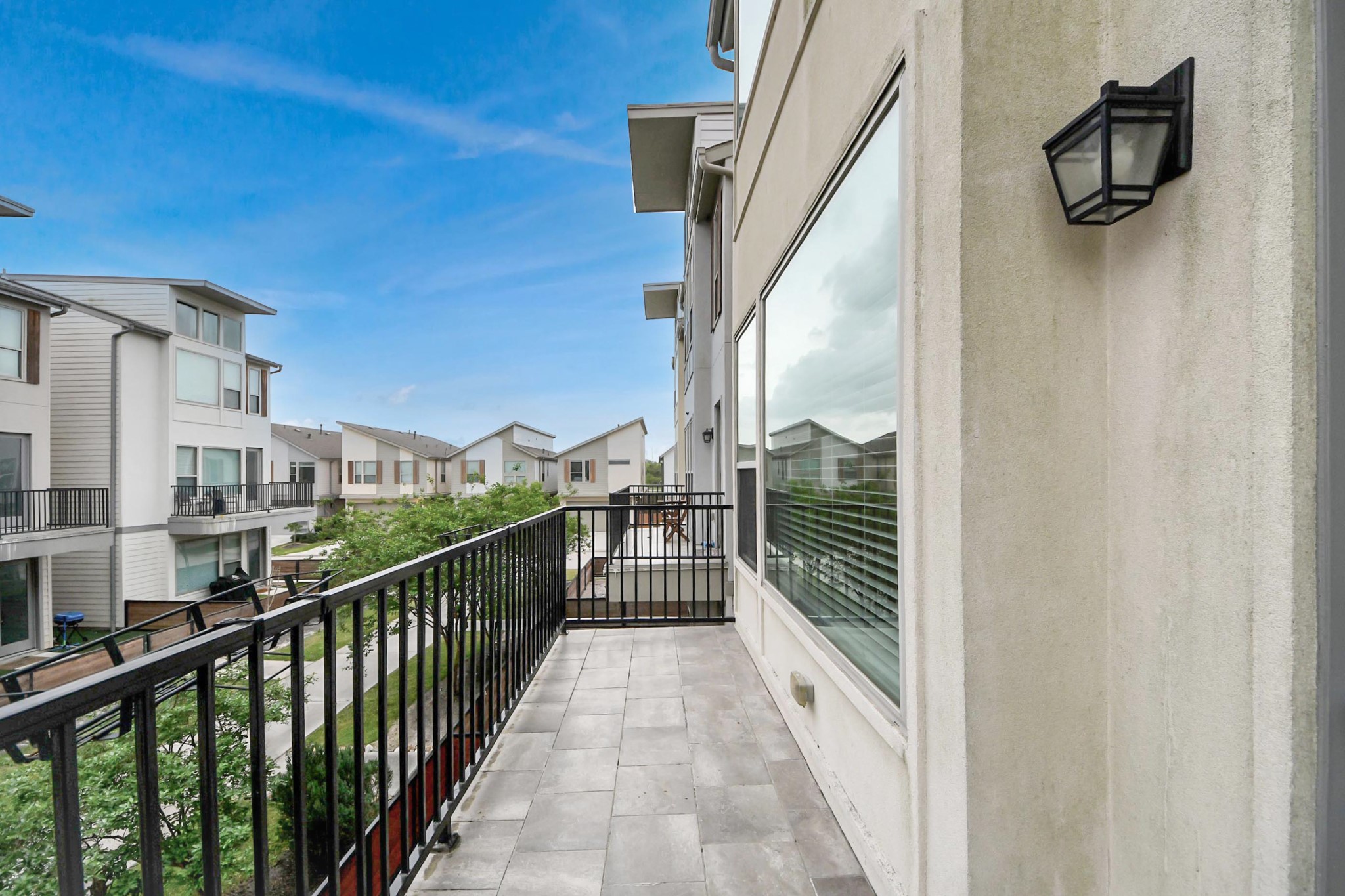 18527 Centro Row Conroe, TX 77385 - Photo 21 of 44 Step out onto the second-floor balcony to enjoy the neighborhood scenery, a perfect perch for sunset viewing.
