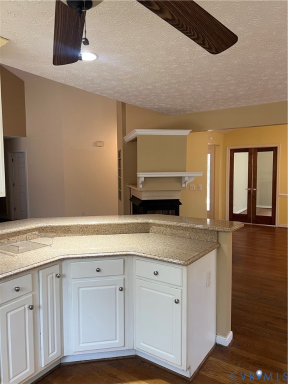 12960 Moody Road Hopewell, VA 23860 - Photo 13 of 33 Kitchen with ceiling fan, white cabinetry, dark wo