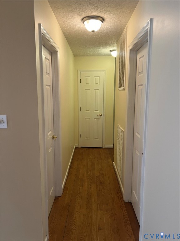 12960 Moody Road Hopewell, VA 23860 - Photo 16 of 33 Hallway featuring dark wood-type flooring and a te