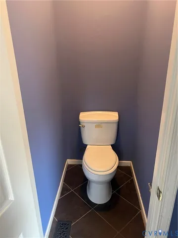 a white toilet sitting in a bathroom