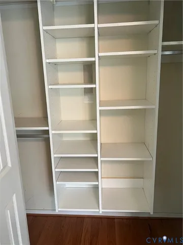 a view of walk in closet with empty racks