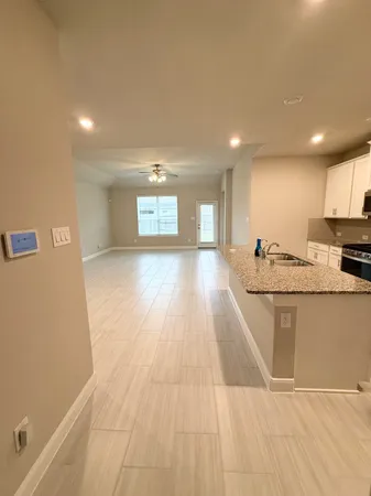 a view of kitchen with stainless steel appliances granite countertop cabinets and wooden floor