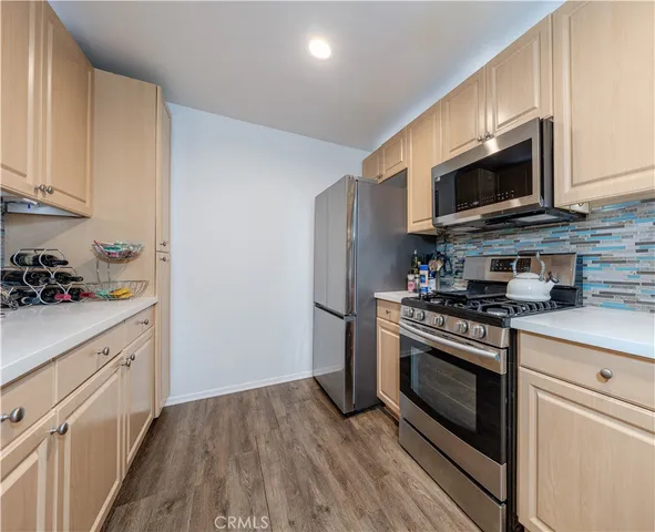a kitchen with stainless steel appliances a stove a microwave sink and cabinets