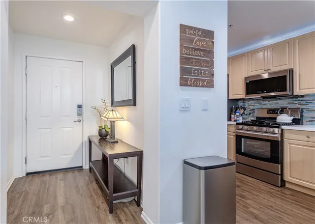 a kitchen with a refrigerator and a stove top oven