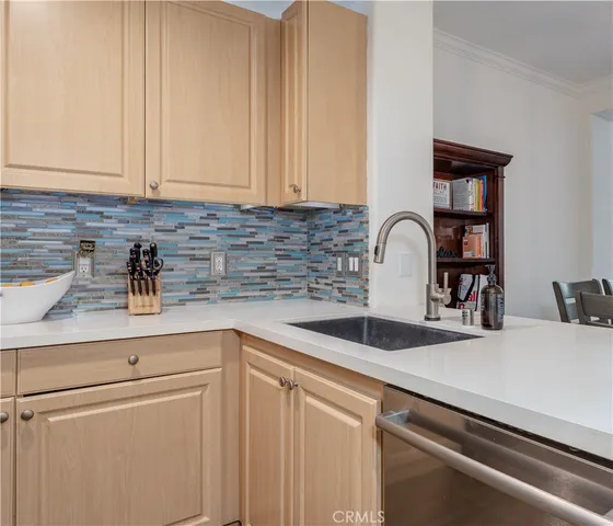 a kitchen with appliances a sink and cabinets
