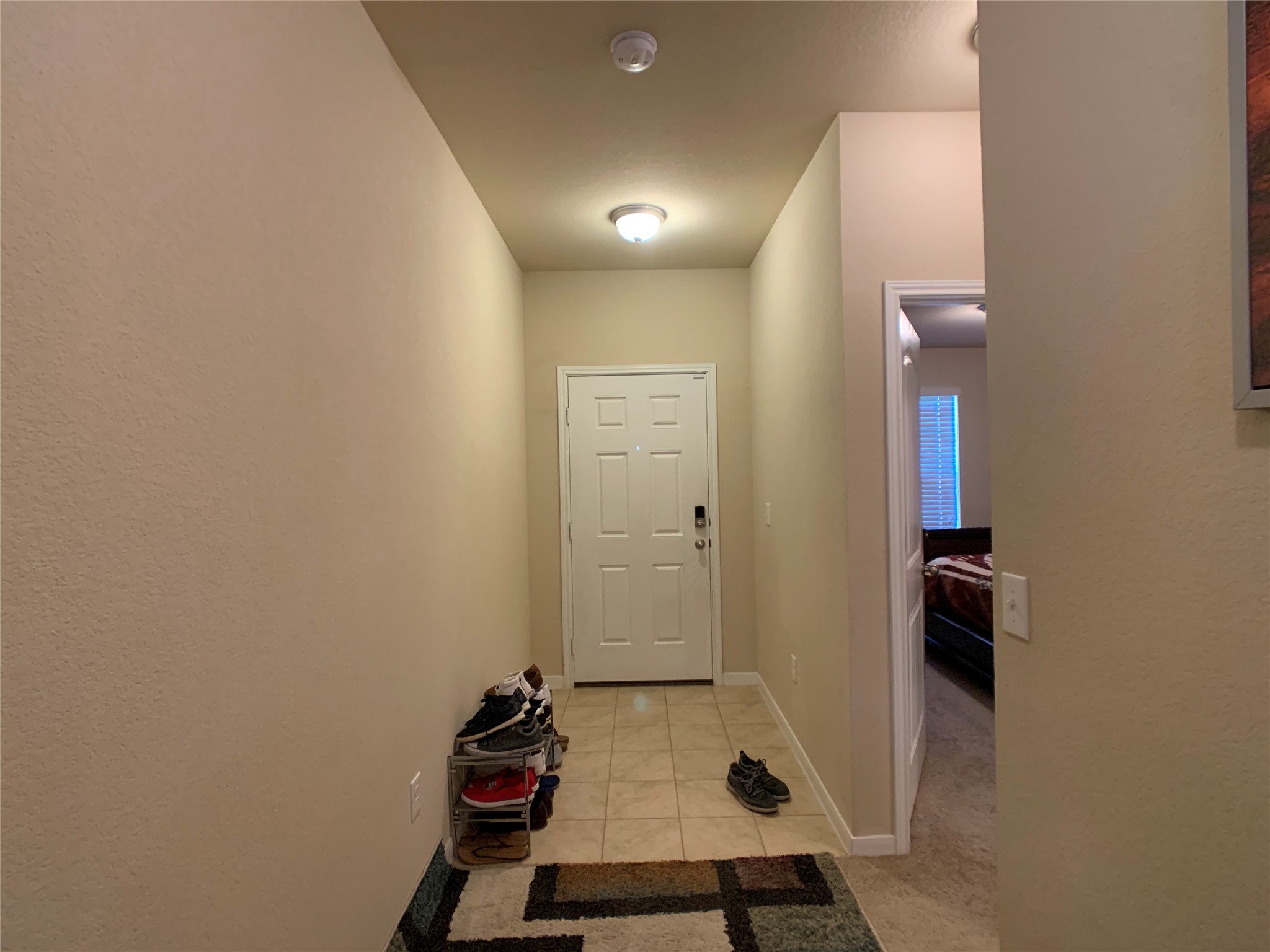5721 Roderick Drive Austin, TX 78724 - Photo 12 of 26 Entryway with tile patterned flooring and carpet