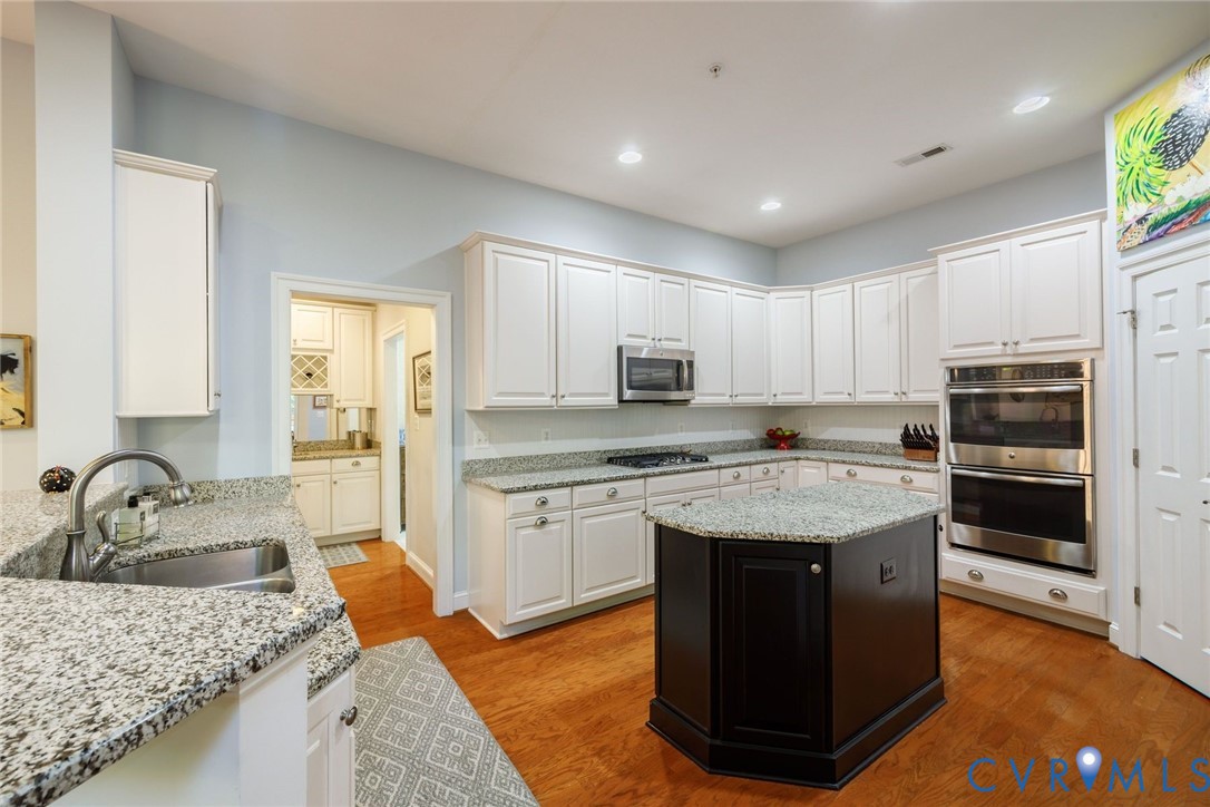 704 Chiswick Park Road Henrico, VA 23229 - Photo 16 of 47 a kitchen with stainless steel appliances granite countertop a sink stove and refrigerator