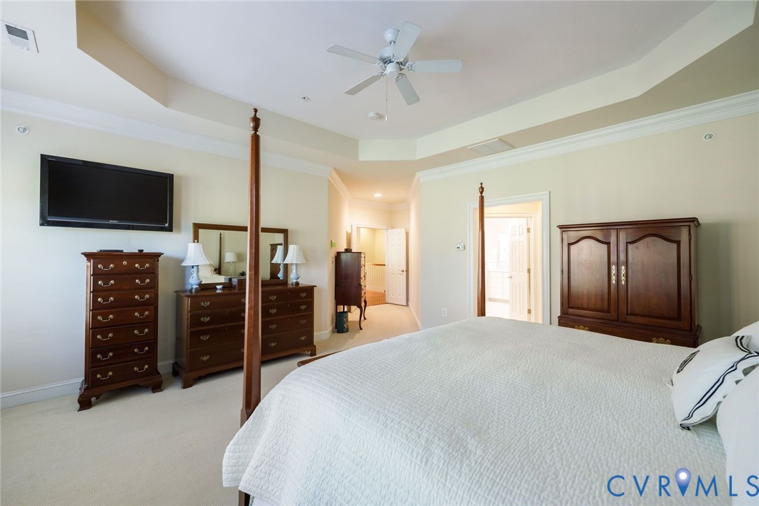 704 Chiswick Park Road Henrico, VA 23229 - Photo 26 of 47 a spacious bedroom with a bed and a flat screen tv