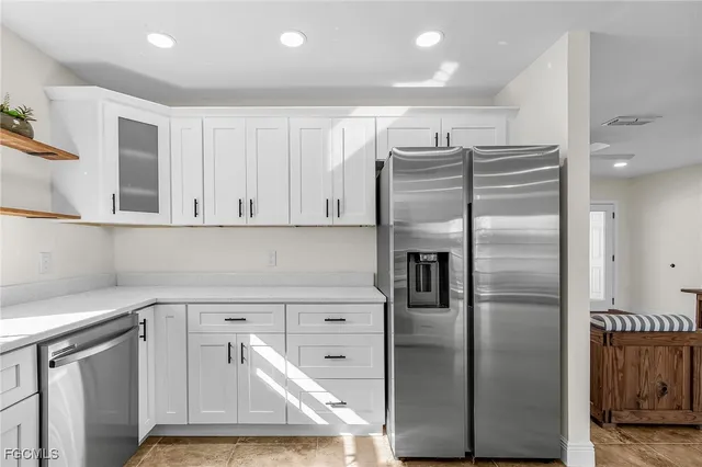 a kitchen with stainless steel appliances cabinets and a refrigerator