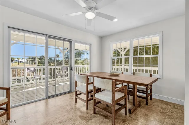a dining room with a glass top table and chairs