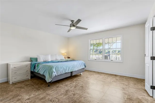 a bedroom with a bed a dresser and a window