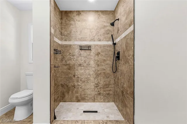 a bathroom with a shower and a toilet