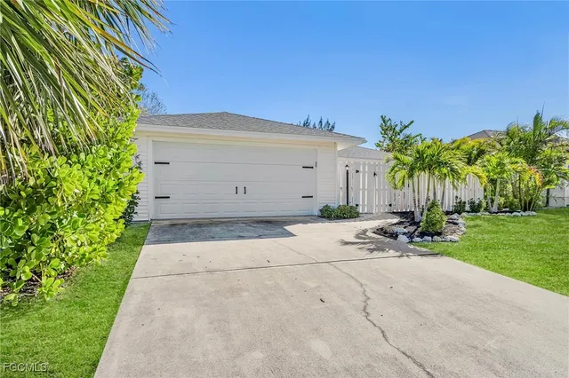 a row of palm trees in front of a house