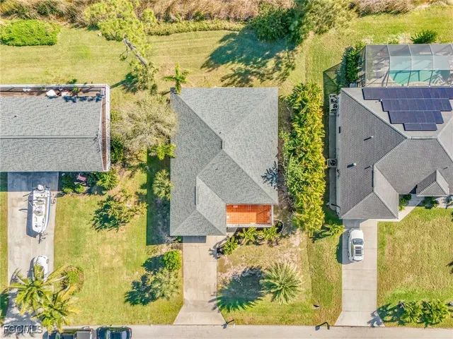 an aerial view of residential houses with outdoor space and swimming pool