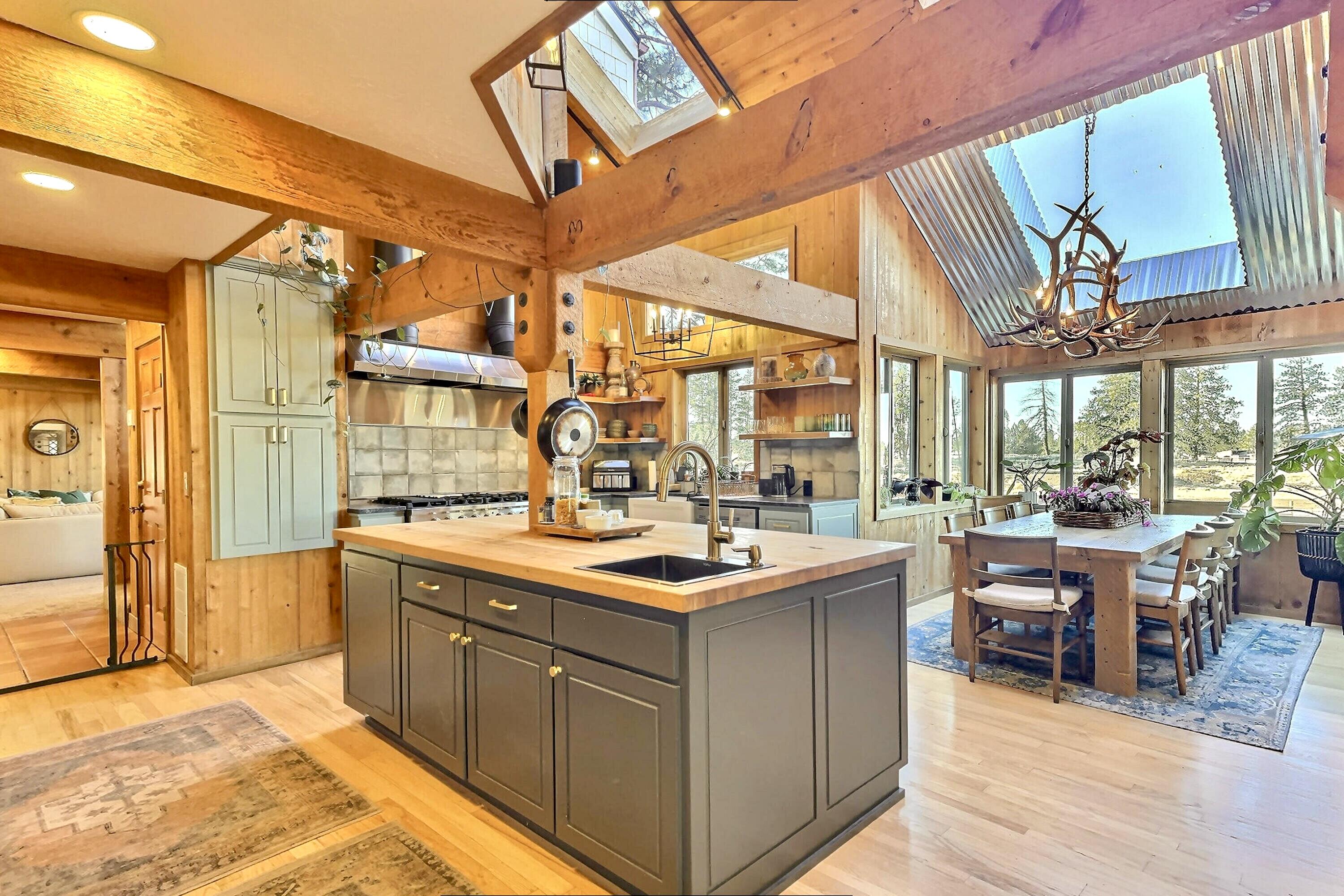 60359 Arnold Market Road Bend, OR 97702 - Photo 12 of 64 chef's kitchen with huge butcher-block island and 2nd prep sink. Dining nook (1) of (2) with skylights throughout