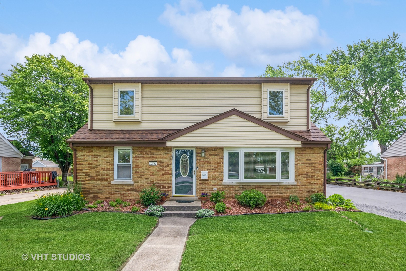 10743 Lombard Avenue Chicago Ridge, IL 60415 - Photo 1 of 20 a front view of a house with a garden and yard