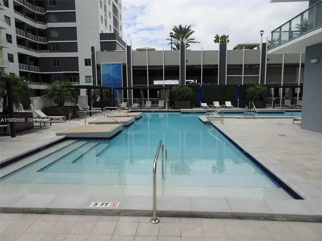 a swimming pool view with a outdoor seating