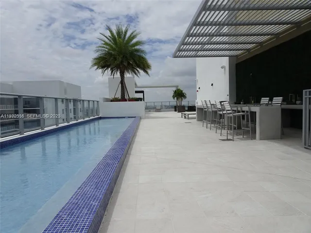 a view of a patio with table and chairs with wooden floor and fence