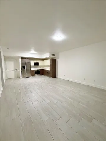 an empty room with closet and windows