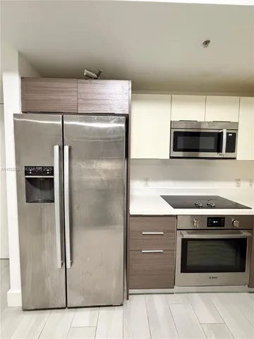 a kitchen with a refrigerator stove and microwave