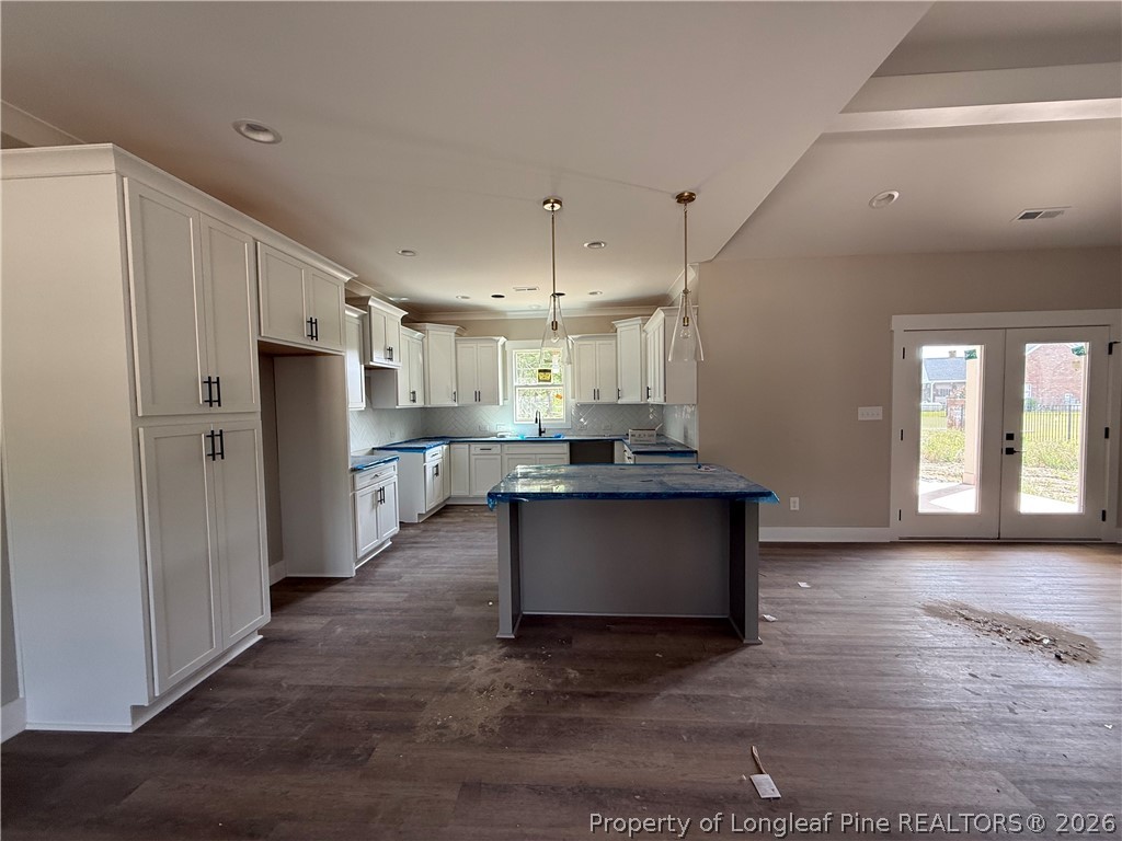 132 Ridge Stone Drive Autryville, NC 28318 - Photo 5 of 26 a kitchen with stainless steel appliances kitchen island granite countertop a refrigerator a stove a sink and a oven