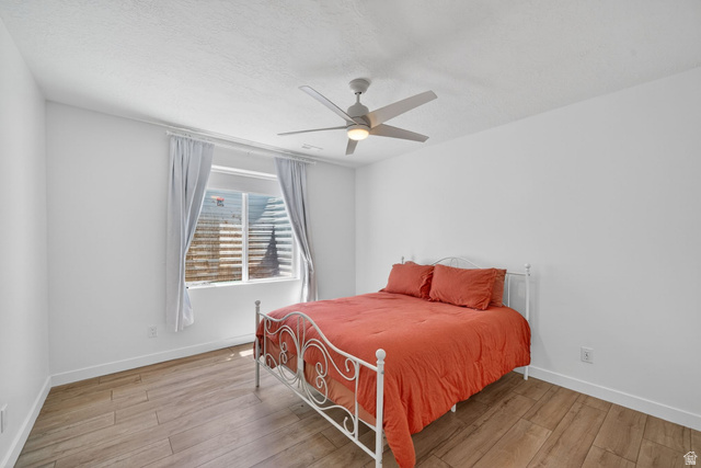 1165 West Union Bench Drive Mapleton, UT 84664 - Photo 42 of 61 Bedroom featuring wood-finish flooring, a ceiling fan with integrated lighting, a single window, white walls, and white baseboards