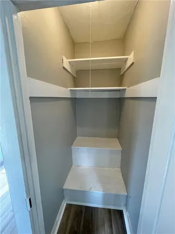 a view of walk in closet with empty racks