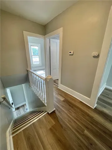 a view of a room with wooden floor