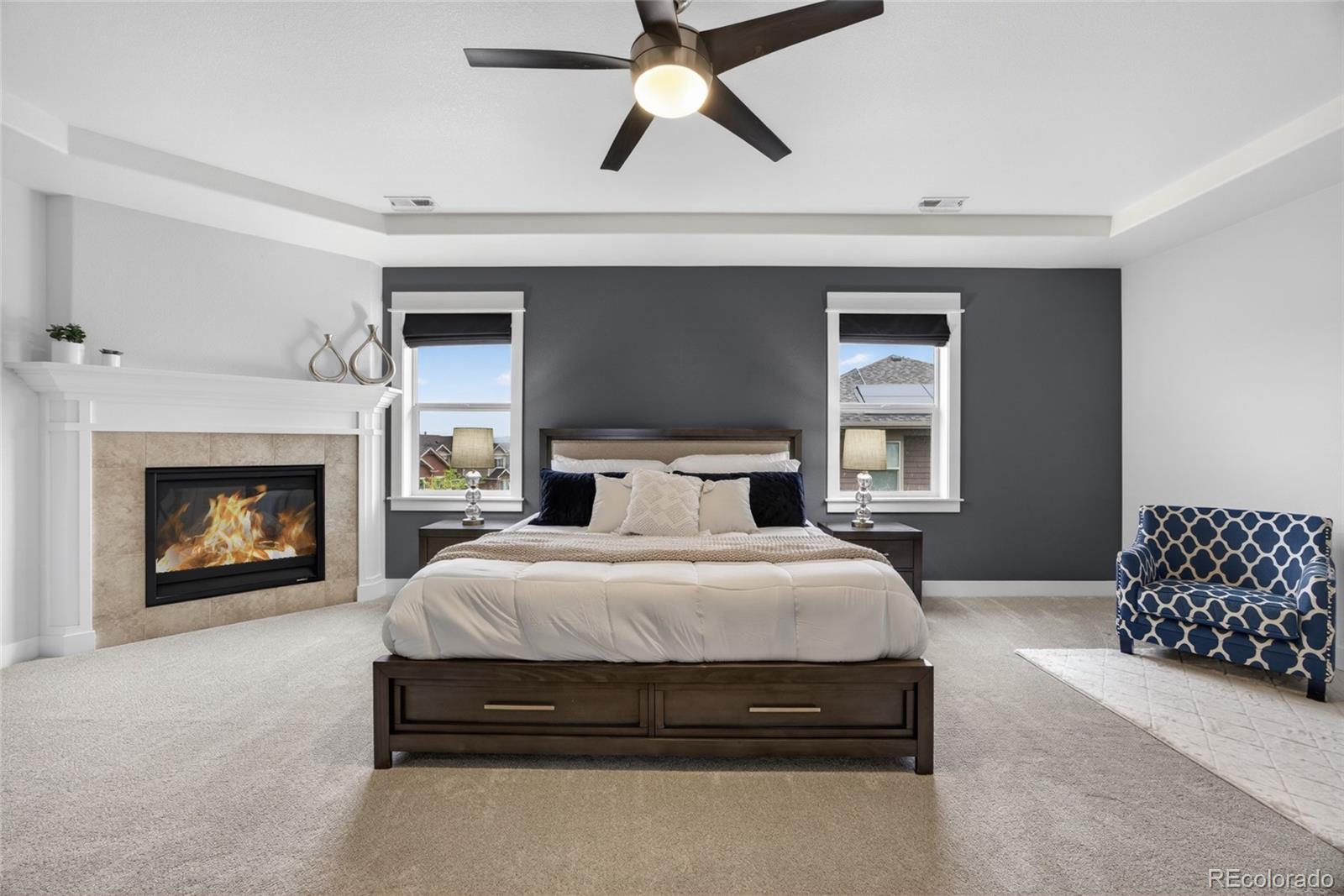 20554 East Shady Ridge Road Parker, CO 80134 - Photo 23 of 49 a spacious bedroom with a bed and a fireplace