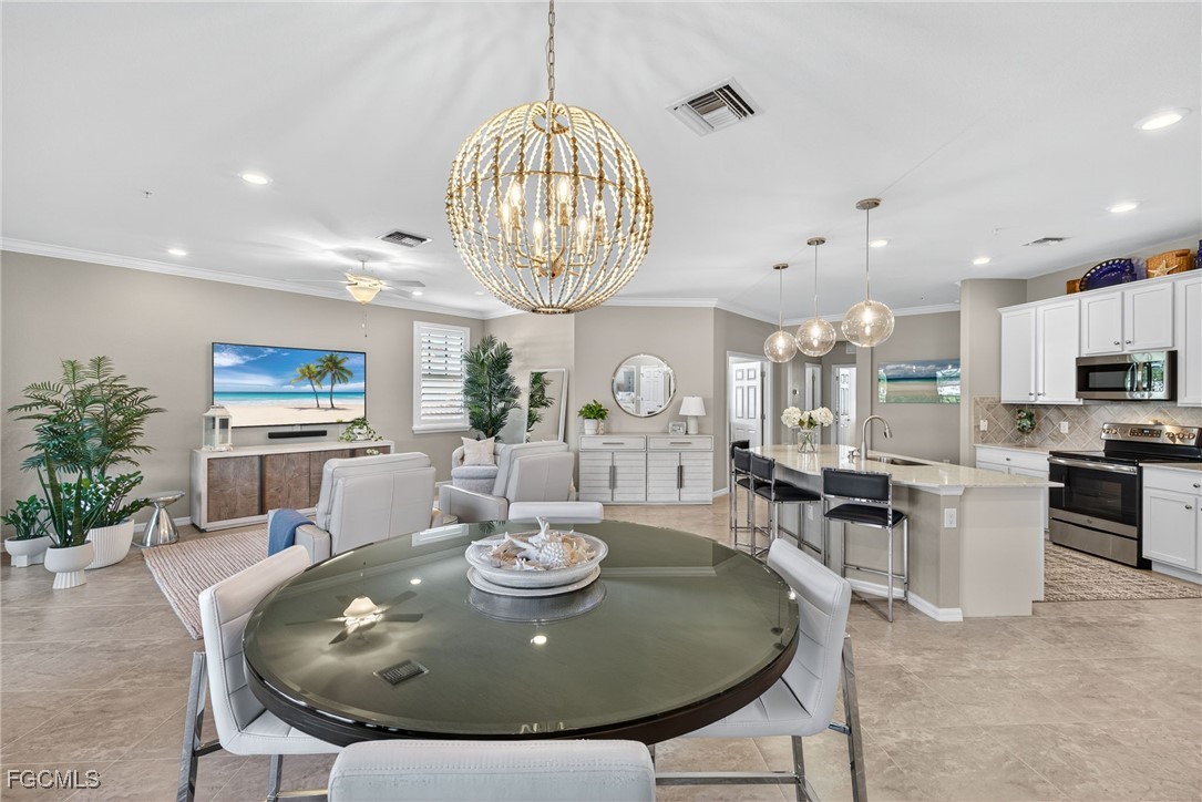 11768 Grand Belvedere Way, Unit 203 Fort Myers, FL 33913 - Photo 13 of 47 a view of a dining room with furniture
