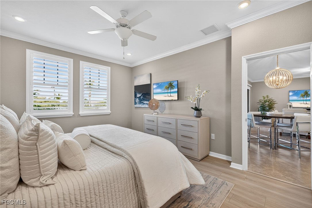 11768 Grand Belvedere Way, Unit 203 Fort Myers, FL 33913 - Photo 15 of 47 a bedroom with a bed and a table with chair