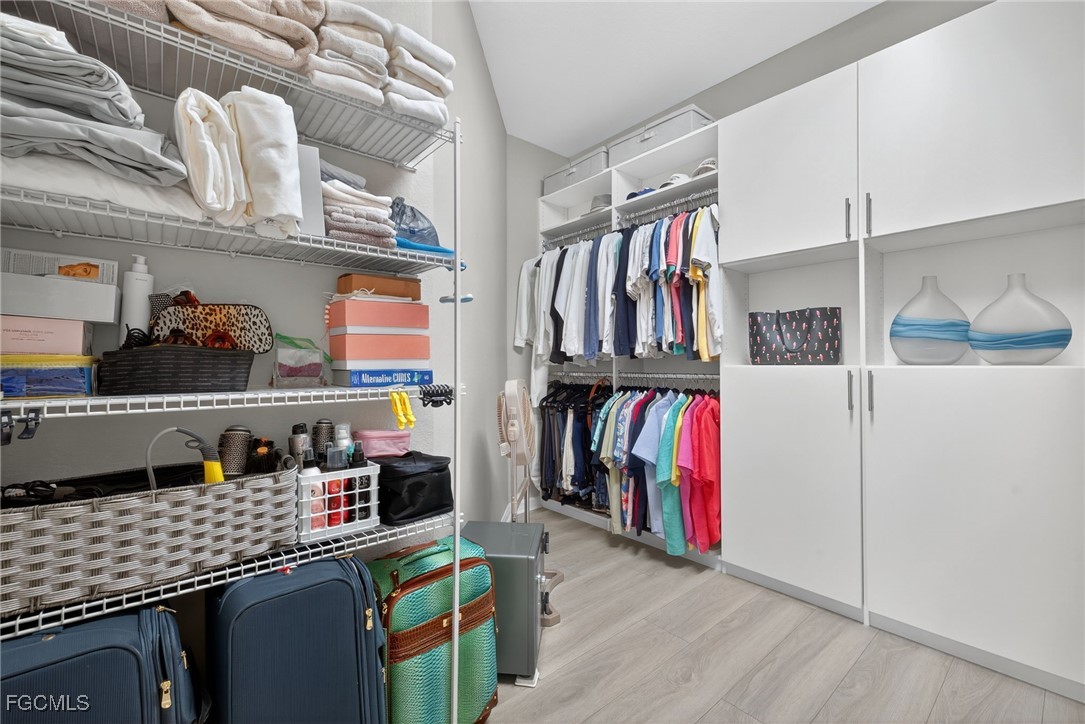 11768 Grand Belvedere Way, Unit 203 Fort Myers, FL 33913 - Photo 19 of 47 a view of walk in closet with clothes and shoes