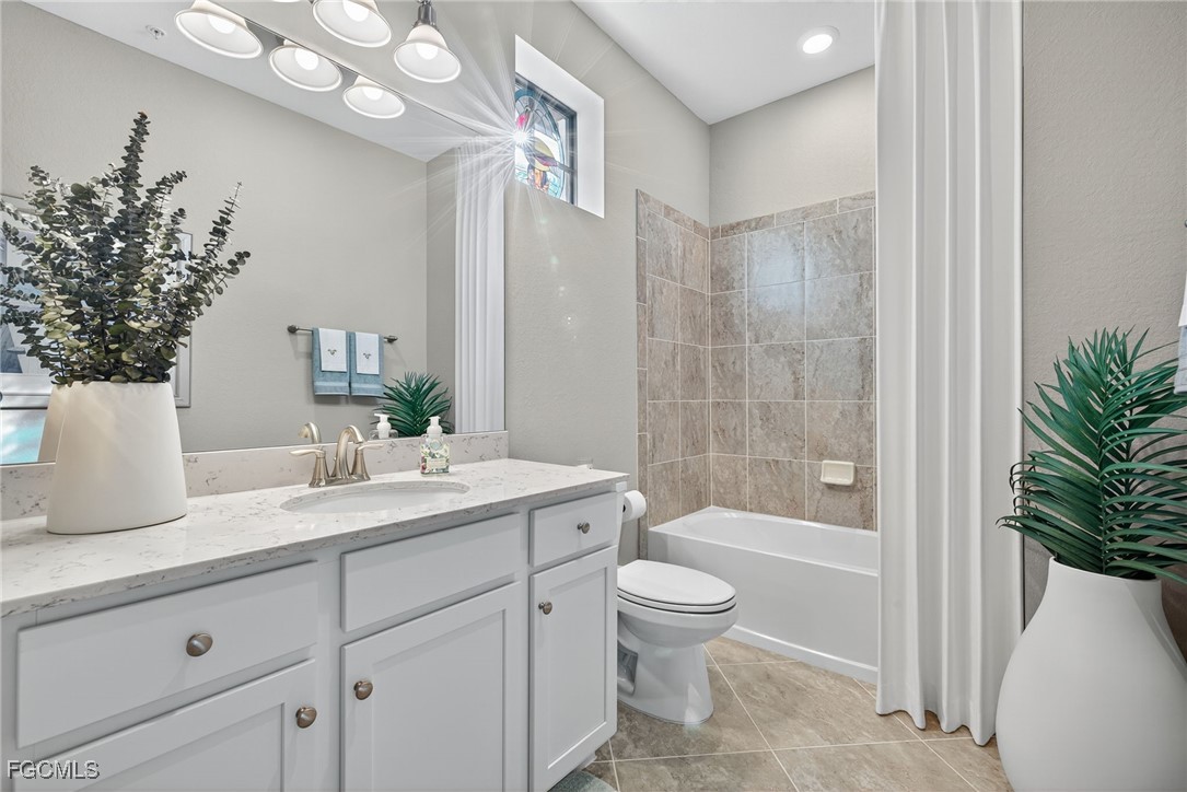 11768 Grand Belvedere Way, Unit 203 Fort Myers, FL 33913 - Photo 22 of 47 a bathroom with a granite countertop sink a toilet and bathtub