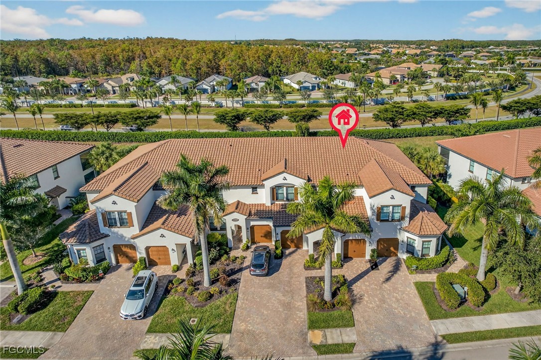11768 Grand Belvedere Way, Unit 203 Fort Myers, FL 33913 - Photo 26 of 47 an aerial view of residential houses with outdoor space and swimming pool