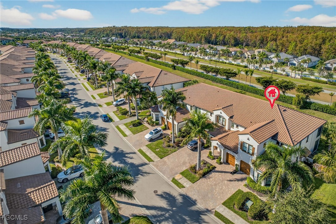 11768 Grand Belvedere Way, Unit 203 Fort Myers, FL 33913 - Photo 27 of 47 an aerial view of residential building and lake