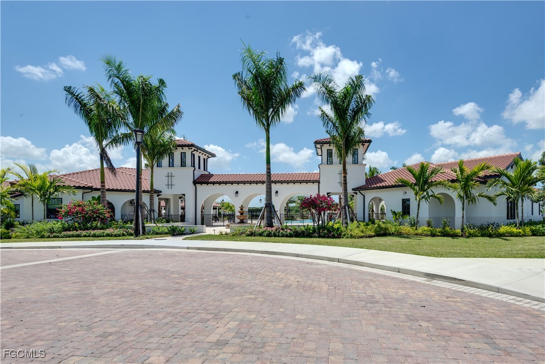 11768 Grand Belvedere Way, Unit 203 Fort Myers, FL 33913 - Photo 33 of 47 a front view of multi story residential apartment building with yard and green space