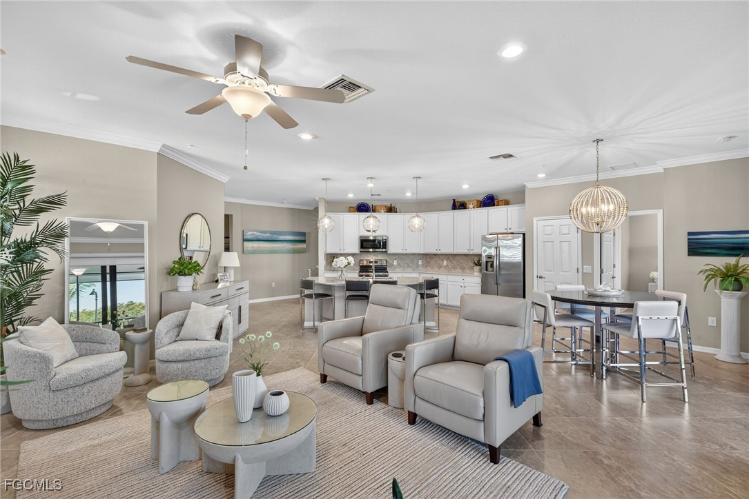 11768 Grand Belvedere Way, Unit 203 Fort Myers, FL 33913 - Photo 4 of 47 a living room with furniture kitchen view and a chandelier